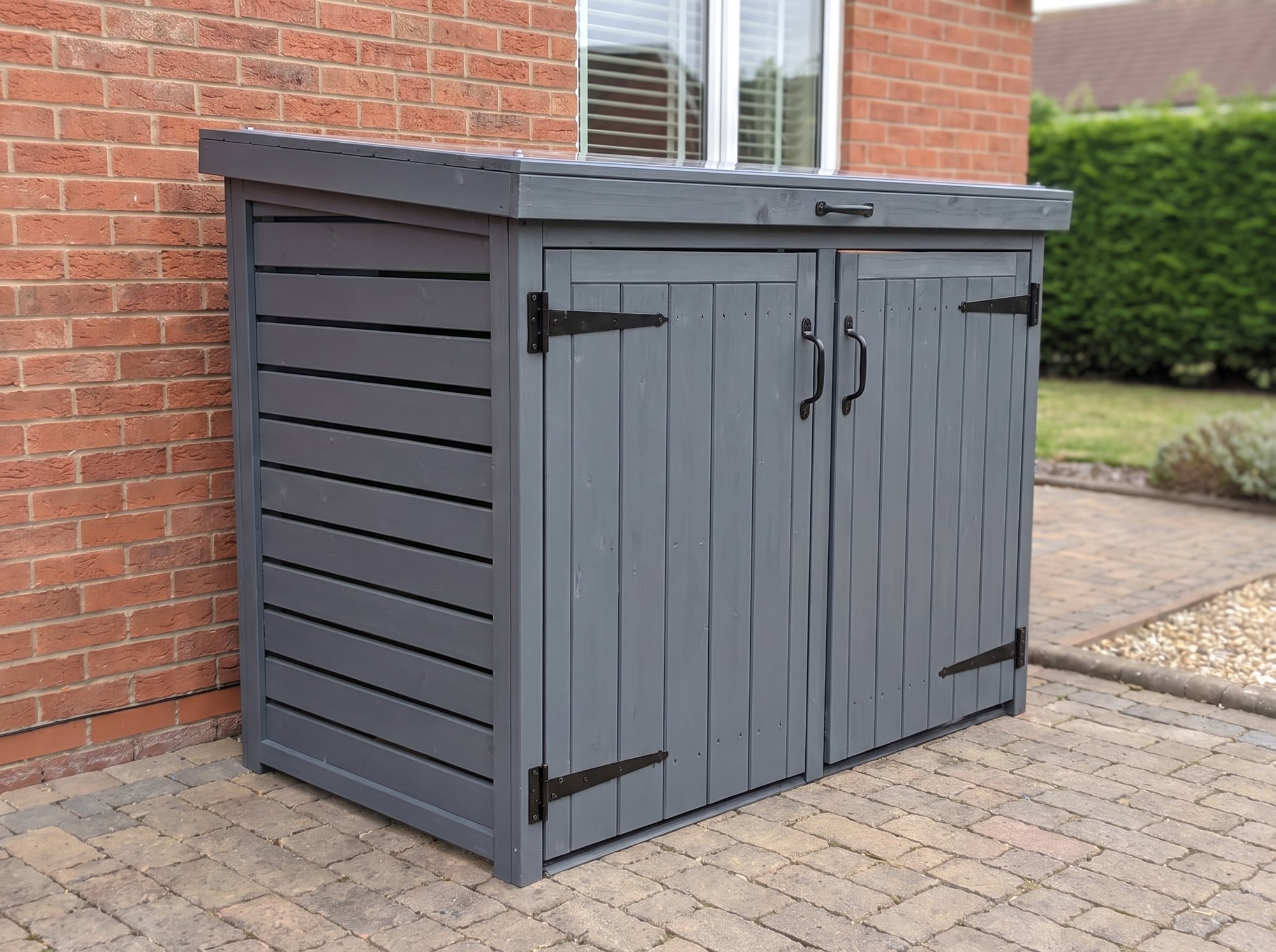 Radley double wheelie bin store closed, seen from a three-quarter angle showing the slatted side