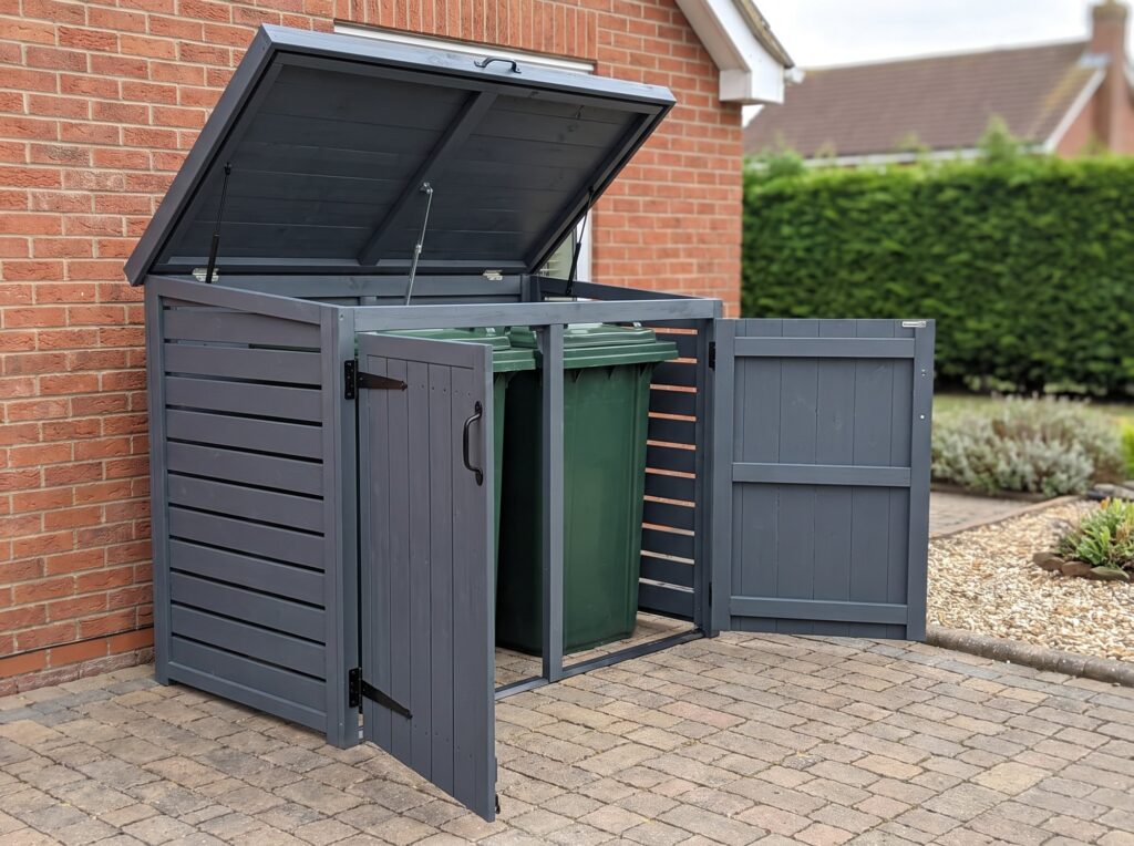 Radley double wheelie bin store open showing two 240 litre bins inside on a block-paved driveway